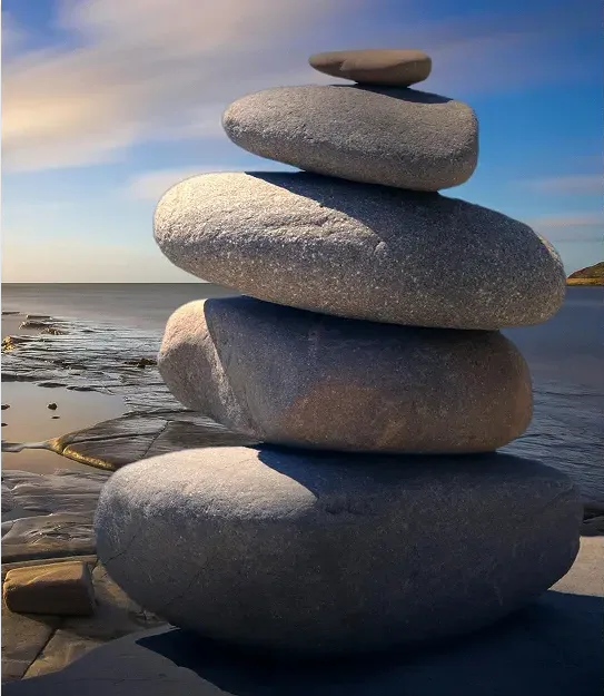 Smooth stones balanced in a stack by the water